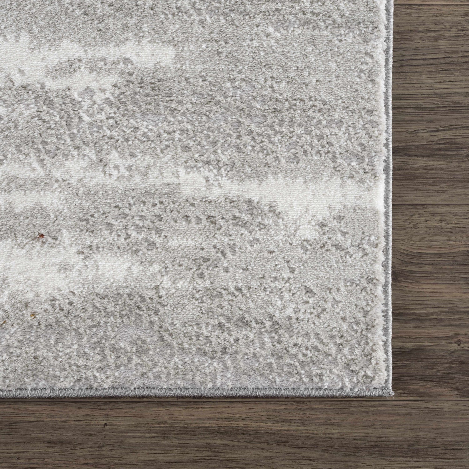 Close-up of the Live Marble Gray Area Rug showing its textured charcoal, light gray, and off-white pattern. Swatch