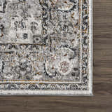 Close-up of the Liverpool Dark Gray Area Rug showing its traditional charcoal, gray, rust, and off-white pattern. Swatch