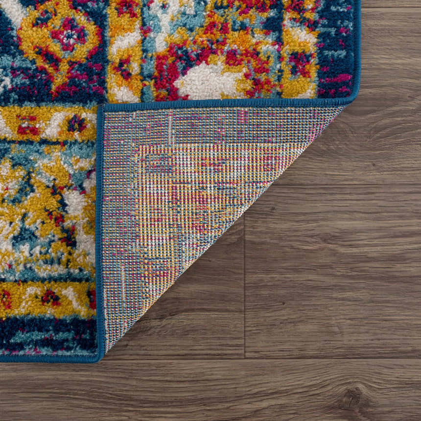 Close-up of the Istanbul Vintage Navy Area Rug showing the colorful bohemian pattern and woven backing. Fold