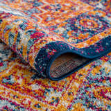 Close-up of the Istanbul Medallion Blue & Orange Area Rug showing its traditional pattern, navy border, and textured polypropylene. Fold