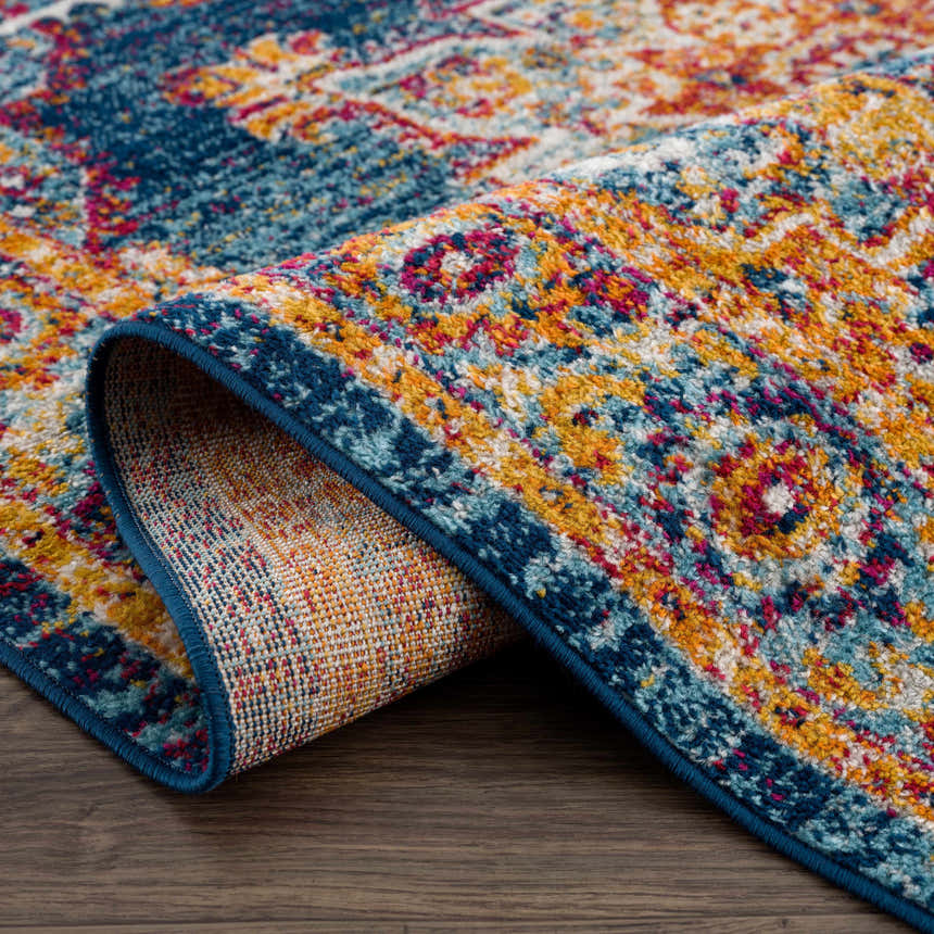 Close-up of the Istanbul Medallion Blue & Orange Area Rug showing its traditional medallion pattern and woven texture. Fold