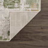 Close-up of the Liveri Green Mosaic Rug showing its abstract pattern, colors, texture, and backing. Fold