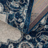 Close-up of the Istanbul Blue Area Rug showing the ivory, navy, and gray vintage-style pattern and woven construction. Fold