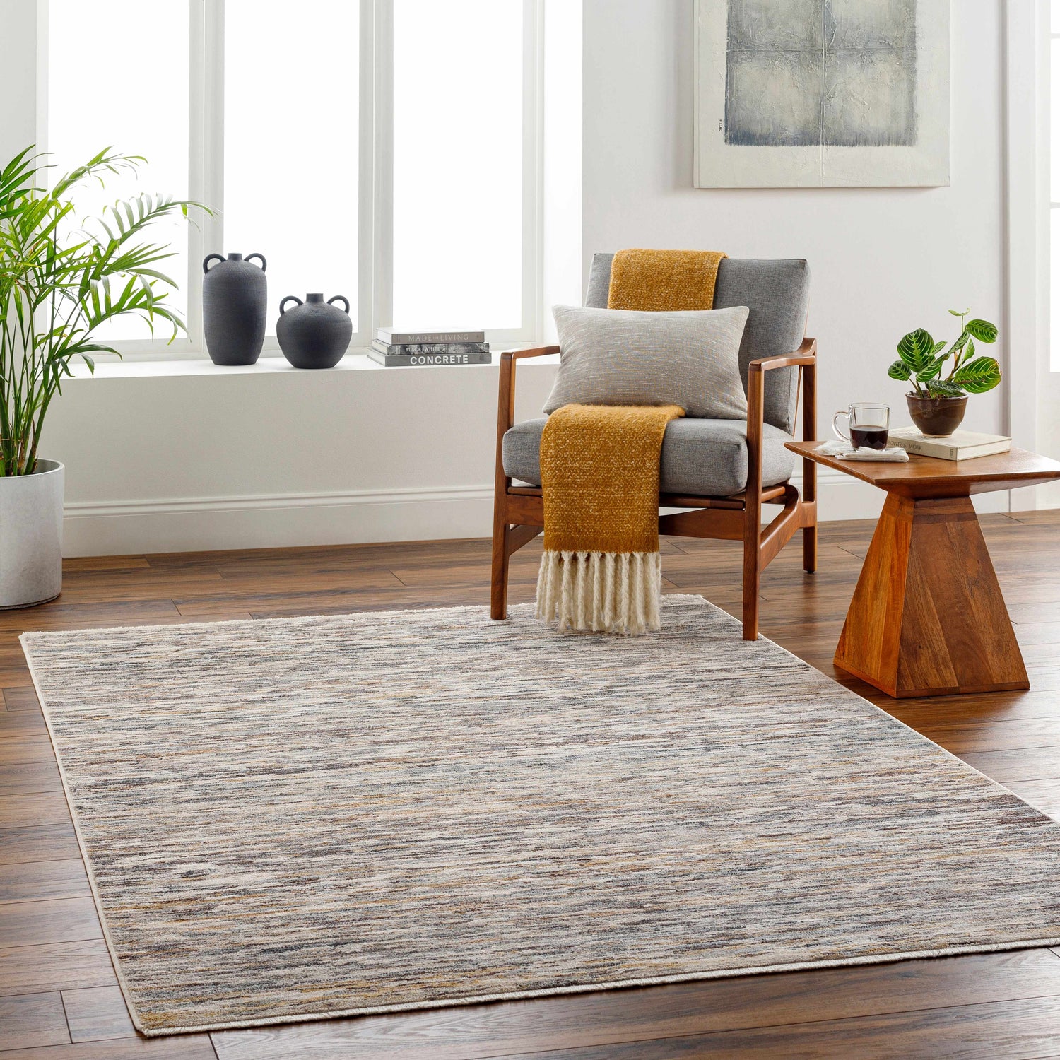 Living room scene with Apria area rug in dark beige, brown, and gray tones. Contemporary style. Roomscene-Rectangle