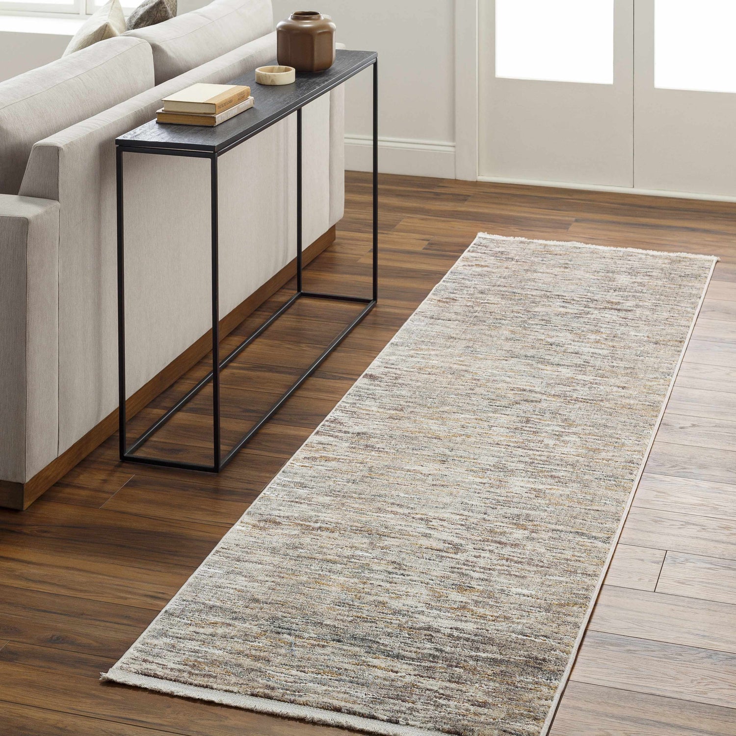 Living room scene with Apria Area Rug runner in beige, brown and gray tones on hardwood floor. Modern decor. Roomscene-Runner