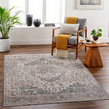 Living room scene with a beige and charcoal Rada Area Rug, gray chair, and wood accents. Roomscene-Rectangle