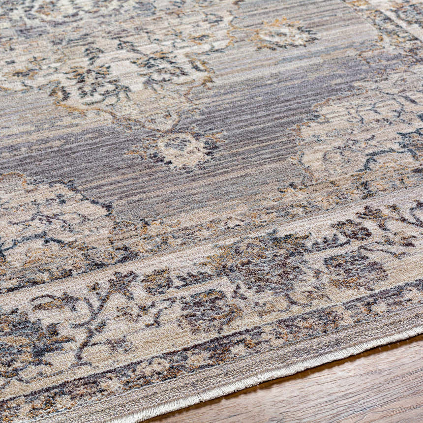 Close-up of the Cream Brown Zola Area Rug, a traditional style rug with beige, gray, and brown floral pattern on a wood floor. Texture