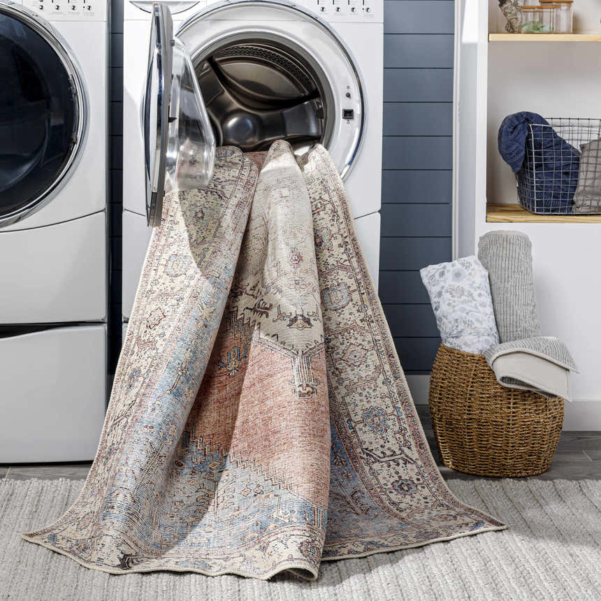 Sacriston Washable Area Rug in laundry room coming out of washing machine. Bohemian style rug with aqua, rose, and tan colors. Washing-Machine