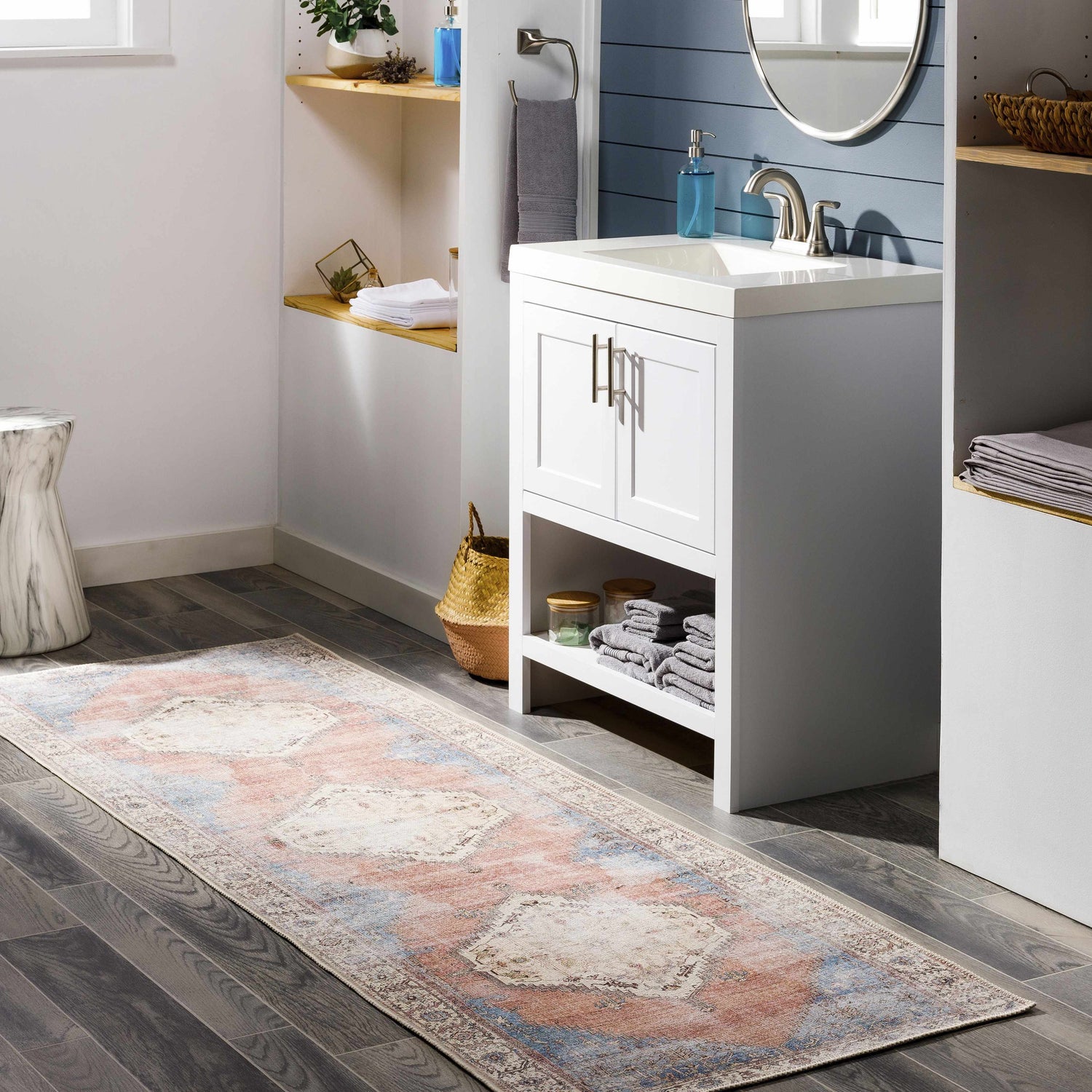 Bathroom scene with a Sacriston Washable Area Rug runner in aqua, rose, and blue, adding a bohemian touch to the gray wood floor. Roomscene-Runner