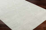 Close-up of the Aldis Grey Plush Textured Washable Rug showing its geometric pattern and soft, plush texture. Corner