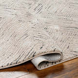 Close-up of a beige Garza Diamond Textured Washable Rug showing its diamond pattern and soft, textured weave. Fold