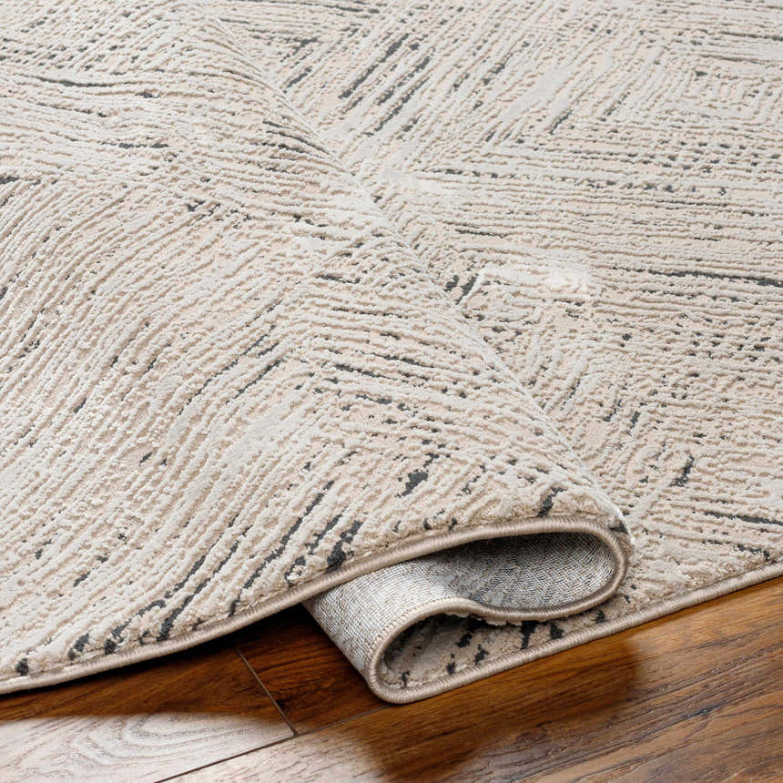 Close-up of a beige Garza Diamond Textured Washable Rug showing its diamond pattern and soft, textured weave. Fold