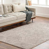 Living room scene with a beige sofa and a Garza Diamond Textured Washable Rug in beige and gray on a wood floor. Roomscene-Rectangle