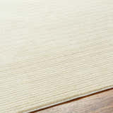 Close-up of a Lambswool Kini Plush Textured Washable Rug showing its soft, plush texture and subtle striped design. Texture