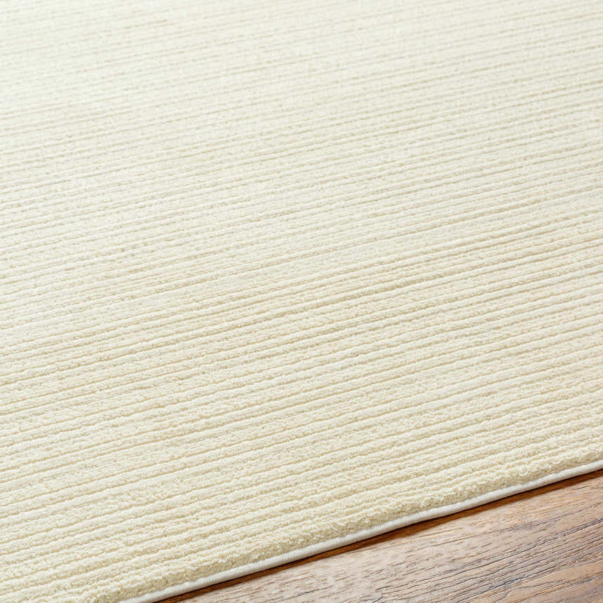 Close-up of a Lambswool Kini Plush Textured Washable Rug showing its soft, plush texture and subtle striped design. Texture