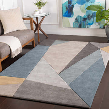 Living room scene with a Salida Modern Wool Rug in charcoal, sage, and gray geometric design. Mid-century modern style. Roomscene-Rectangle
