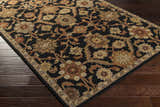Close-up of the Salix Hand Tufted Black Wool Rug, featuring a floral pattern in brick red, camel, mustard, and olive tones. Corner