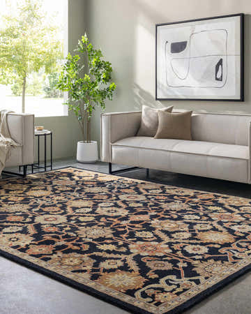 Living room with a Salix Hand Tufted Black Wool Rug, beige sofa, modern art, and indoor tree. Roomscene-Rectangle