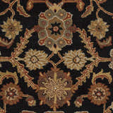 Close-up of the Salix Hand Tufted Black Wool Rug, showcasing its floral pattern in brick red, camel, and mustard tones. Swatch