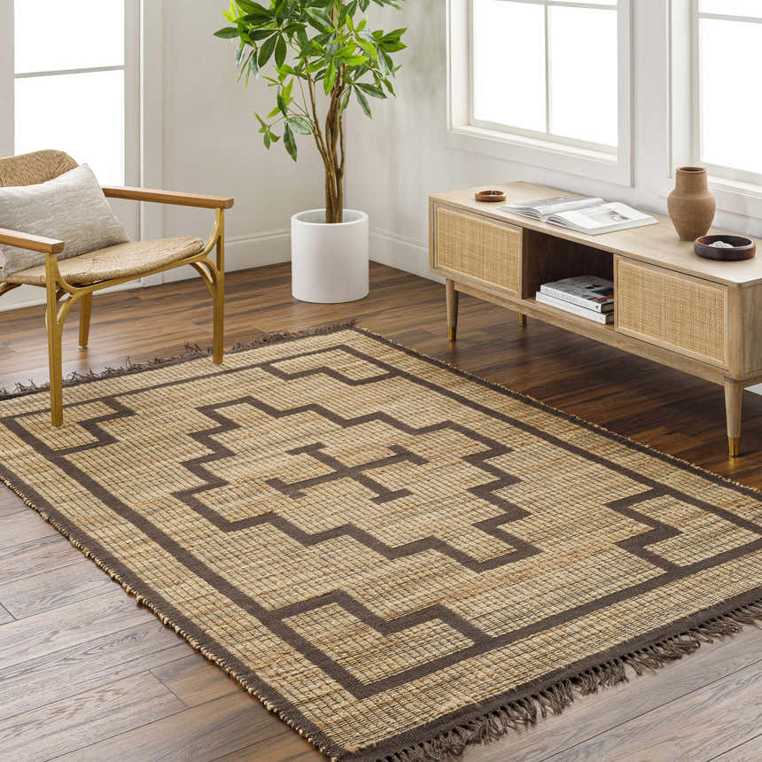 Living room scene with a camel and eggplant Licha Jute Rug, light wood console table, and woven chair. Farmhouse style. Roomscene-Rectangle