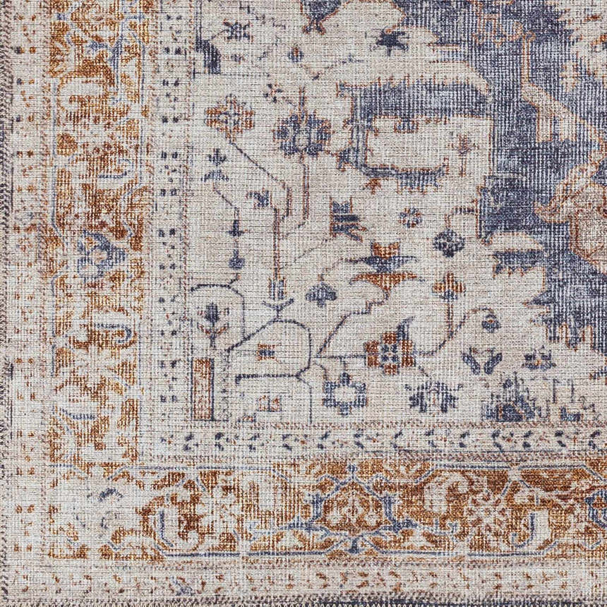 Close-up of the Egor Washable Area Rug. Features a traditional design in dark beige, brown, and ink colors. Machine woven texture. Swatch
