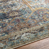 Close-up of the Kaif Washable Area Rug in teal, brown, and cream. Traditional, machine-woven design and textured polyester material. Texture