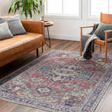 Living room scene with a Reza Red Washable Rug, leather sofa, wood chair, and hardwood floors. Farmhouse style. Roomscene-Rectangle