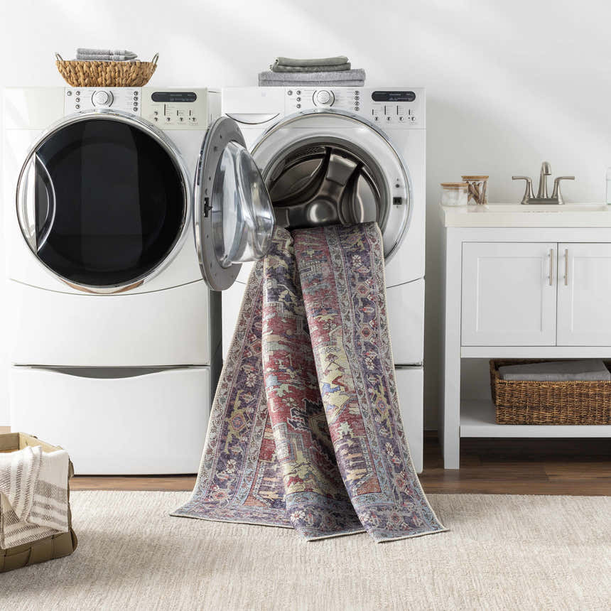 Laundry room scene with Reza Red Washable Rug being washed in a front load washing machine. Washing-Machine