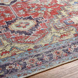 Close-up of the Reza Red Washable Rug showing its traditional, farmhouse design and multi brown, garnet, and bone colors. Texture