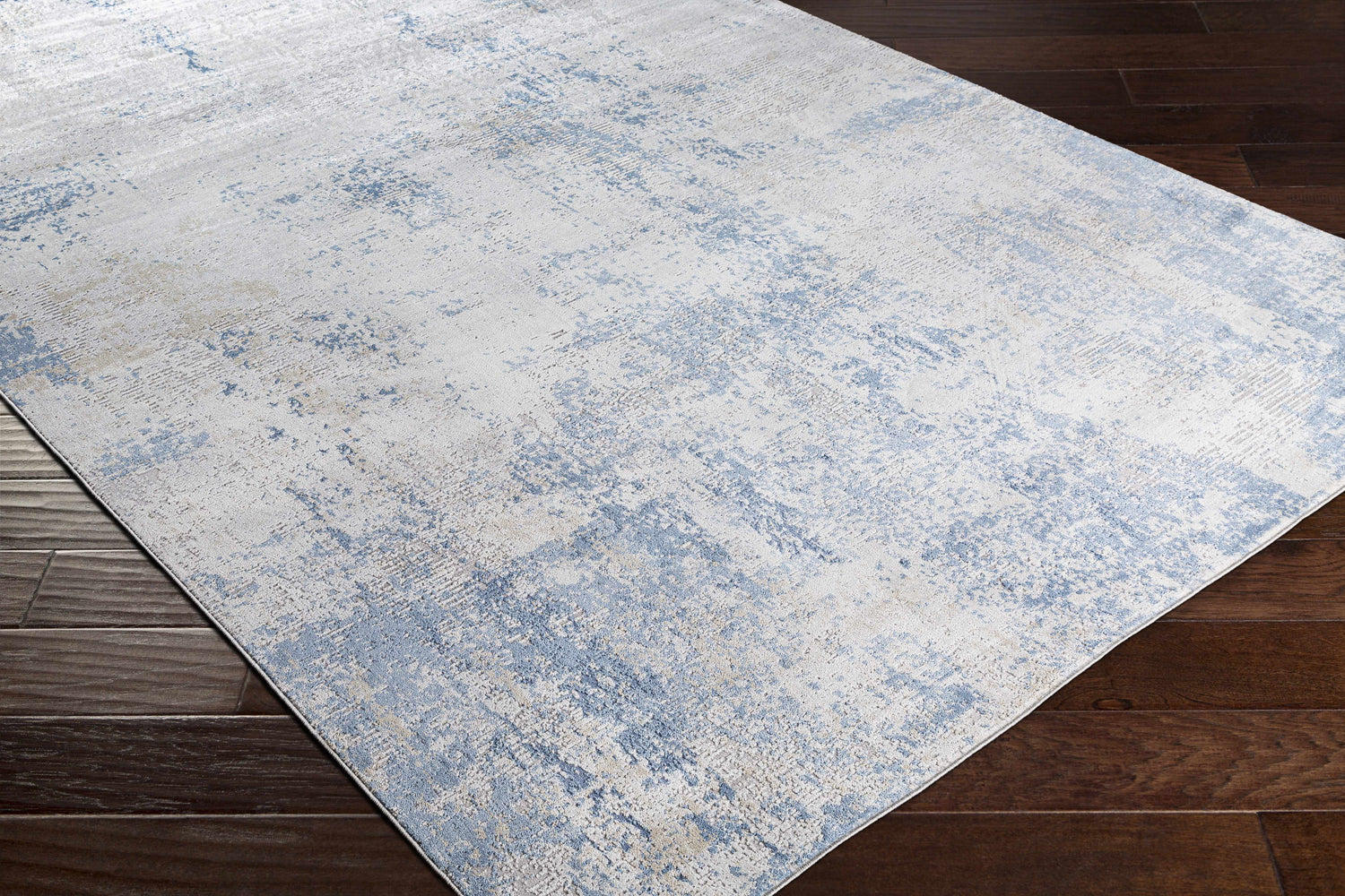 Close-up of the Sapcote Textured Luxe Area Rug, showcasing its light blue, beige, and gray contemporary design. Corner