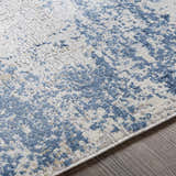 Close-up of the Sapcote Textured Luxe Area Rug, featuring an abstract pattern in light blue, beige, and white. Texture
