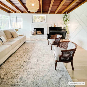Living room with a cream sofa, piano, and Anmoore Luxe Rug in charcoal and cream. Farmhouse style. Roomscene-Rectangle