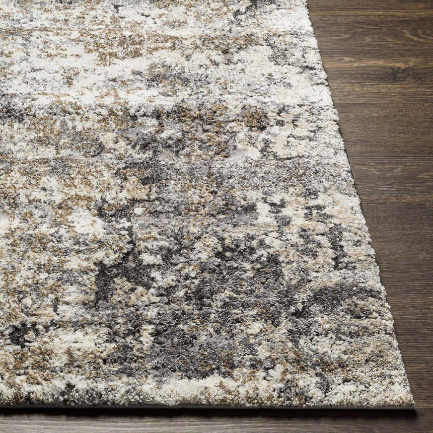 Close-up of the Satsop Rock Pattern Thick Rug. Abstract design in black, charcoal, gray, ivory, and tan. Soft texture. Front