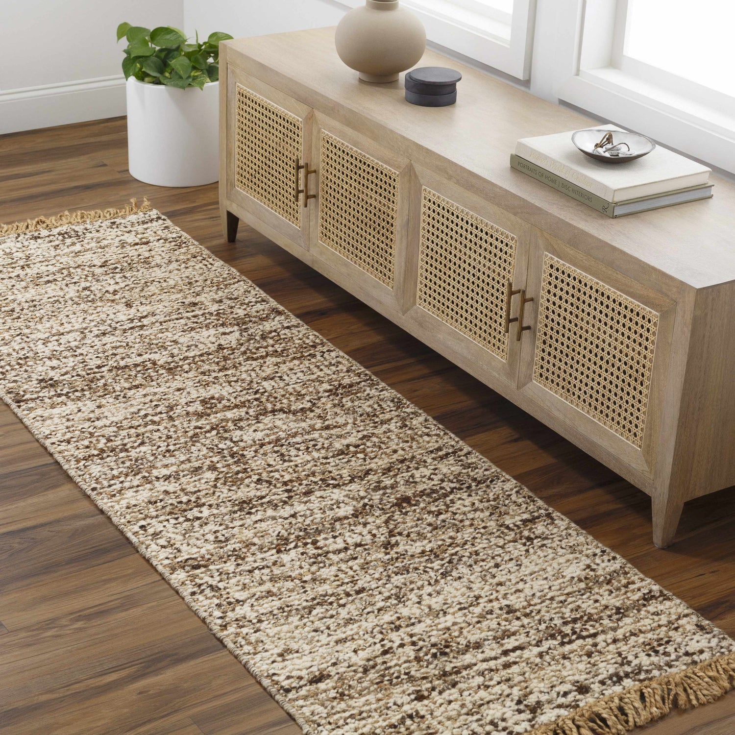 Entryway scene with a Tan Gopi Area Rug runner, wood floors, and a light wood console table. Roomscene-Runner