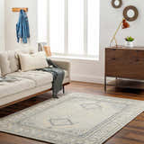 Living room scene with Alena Gray Wool Blend Area Rug, beige sofa, and mid-century modern wood dresser. Roomscene-Rectangle