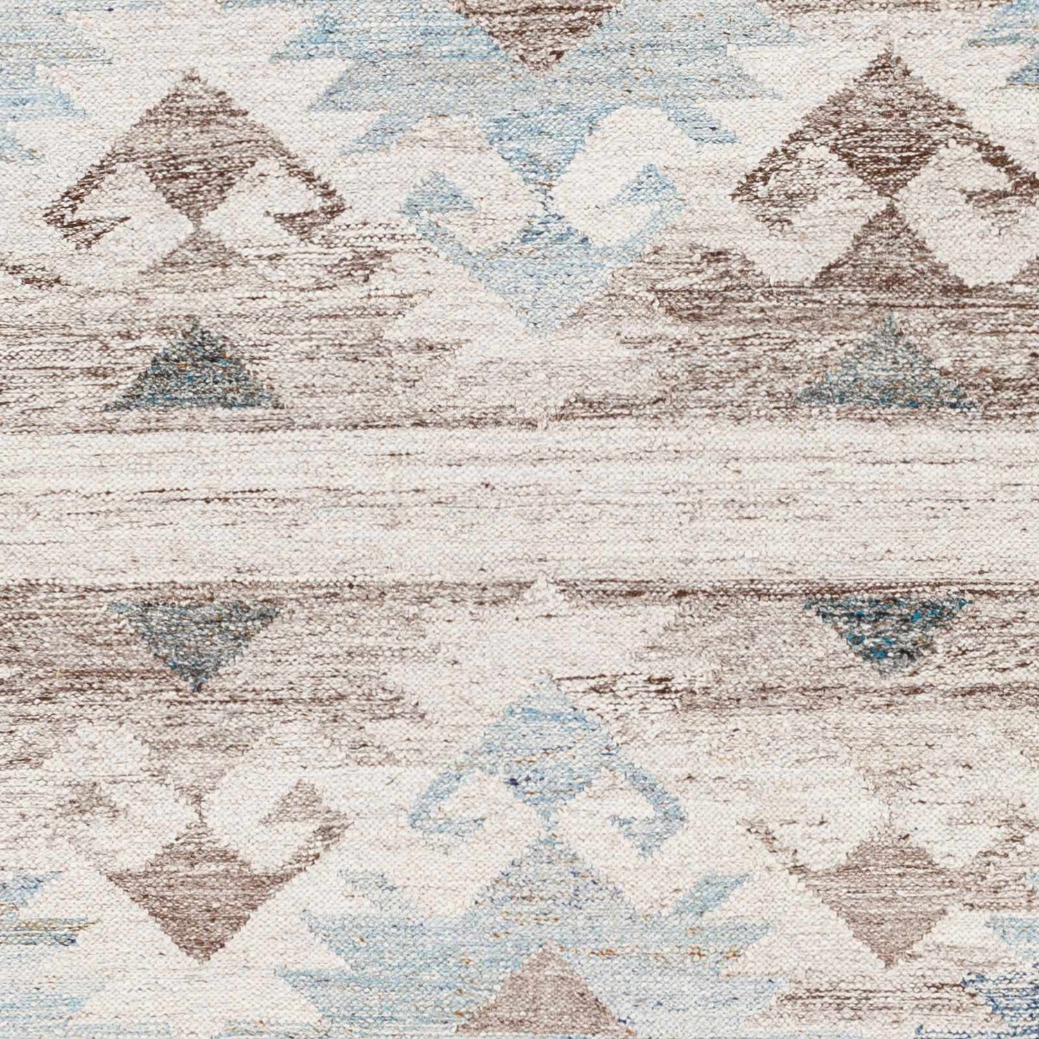 Close-up of Duyen Area Rug showing hand-woven texture and Scandinavian-Southwestern geometric pattern in blue, brown, and white. Swatch