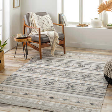 Living room scene with a Scandinavian style Jade Area Rug in black, brown, gray, and ivory tones. Roomscene-Rectangle
