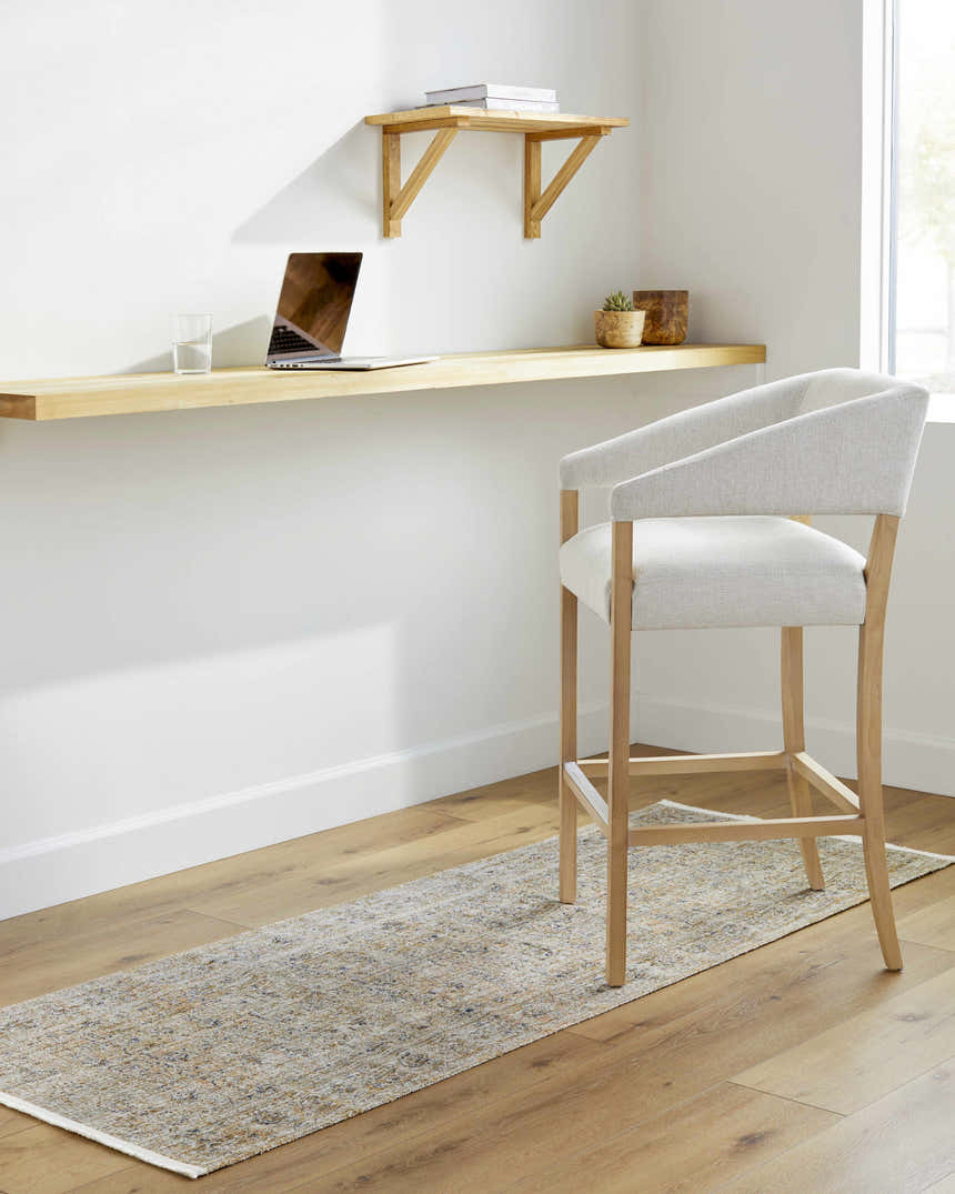 Home office with Margaret Damask Mustard Washable Area Rug runner under a chair, light wood desk, and white walls. Roomscene-Runner