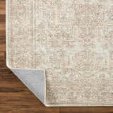 Close-up of the Margot Medallion Dusty Coral rug showing beige, brown, and dusty coral tones and medallion pattern. Fold
