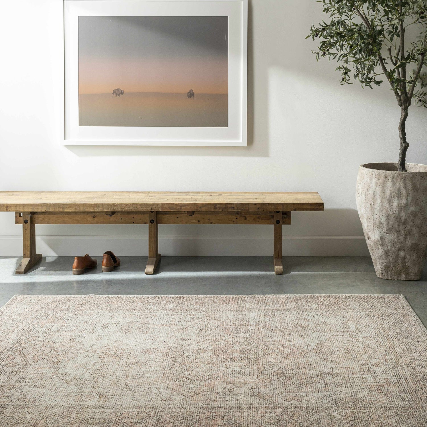 Entryway with a Margot Medallion Dusty Coral rug, wood bench, artwork, and potted olive tree. Farmhouse style. Roomscene-Rectangle