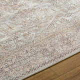 Close-up of the Margot Medallion Dusty Coral rug, a traditional design in beige, bone, and dusty coral on wood flooring. Texture