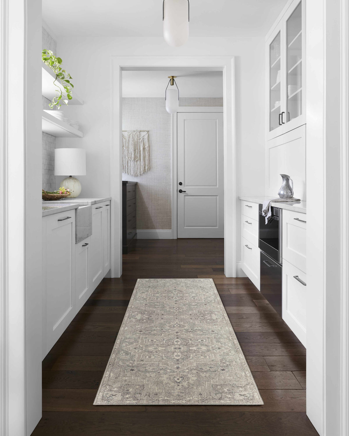 Bright, white kitchen with Margot Medallion Dusty Coral runner rug on dark wood floor. Livabliss x Becki Owens. Roomscene-Runner