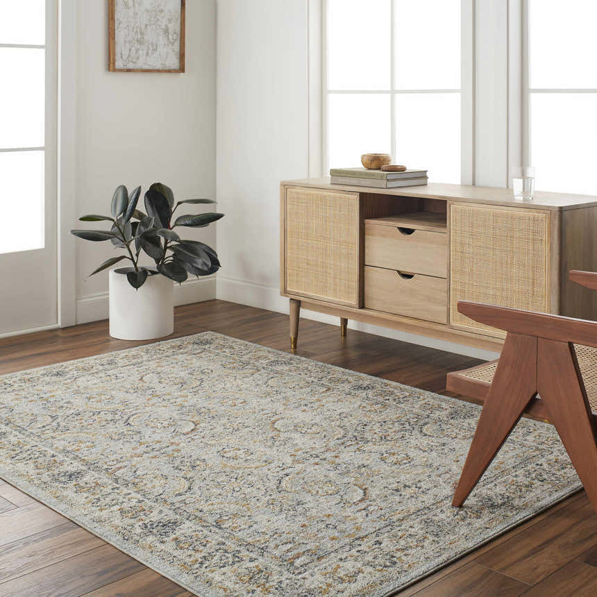 Living room scene with a Jeven Blue Area Rug, wood floors, and a light wood cabinet with rattan details. Roomscene-Rectangle