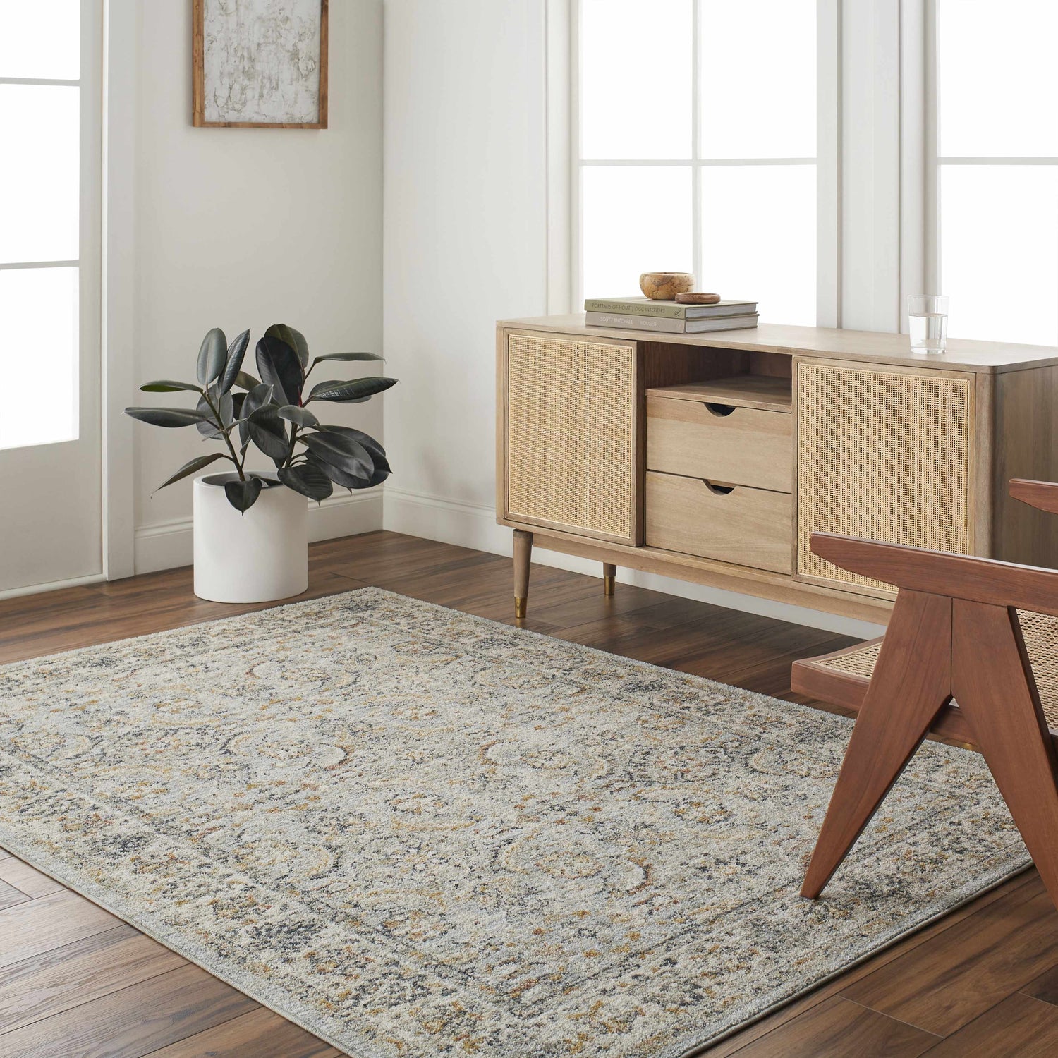 Living room scene with a Jeven Blue Area Rug, wood floors, and a light wood cabinet with rattan details. Roomscene-Rectangle
