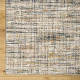 Close-up of Jules Area Rug. Contemporary design in lambswool and light brown with subtle pattern and soft texture. Corner