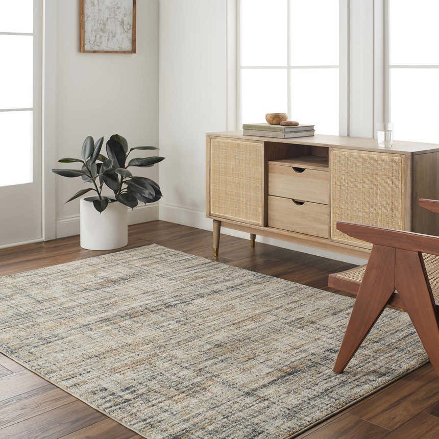 Living room scene with a lambswool and light brown Jules Area Rug, wood floors, and mid-century modern furniture. Roomscene-Rectangle