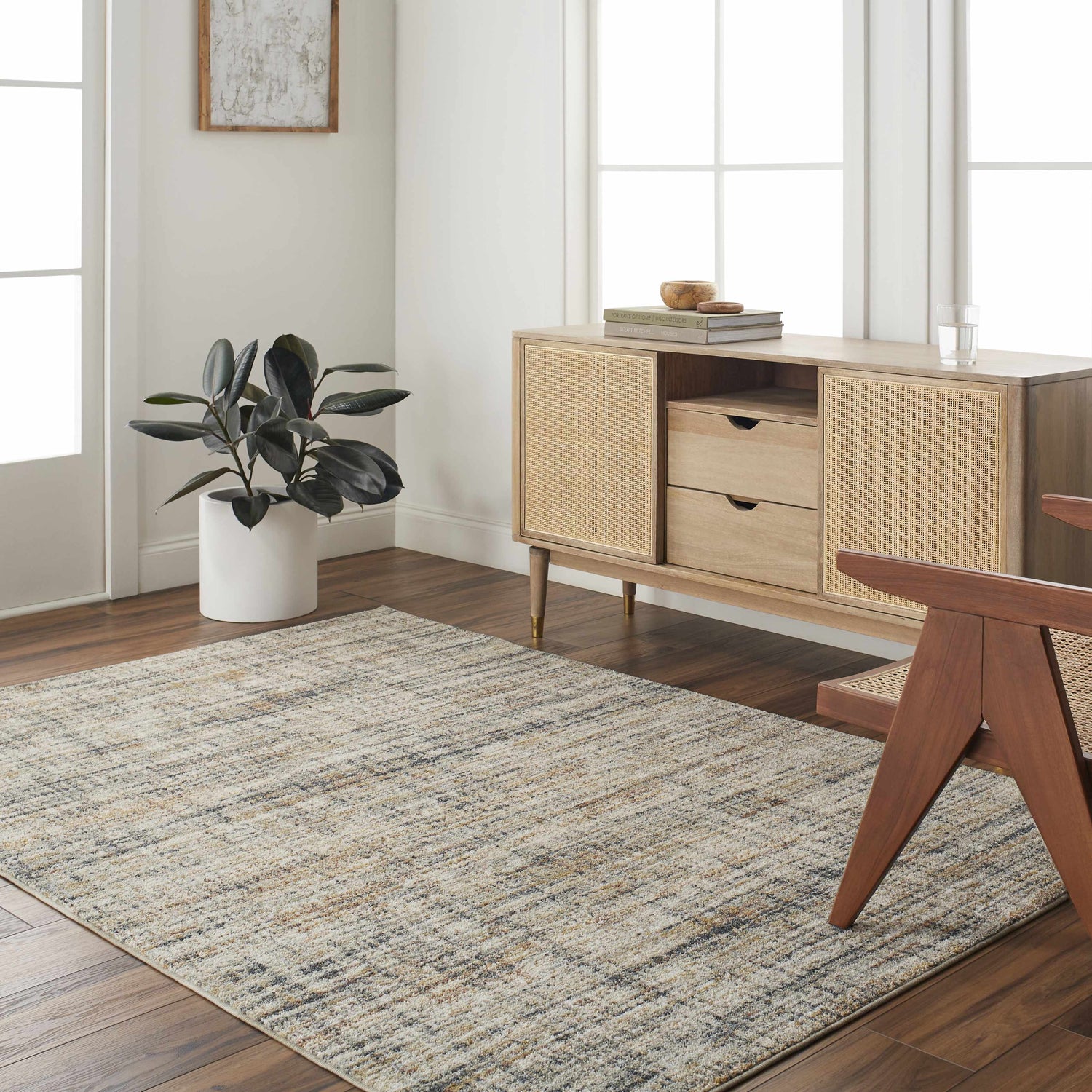 Living room scene with a lambswool and light brown Jules Area Rug, wood floors, and mid-century modern furniture. Roomscene-Rectangle