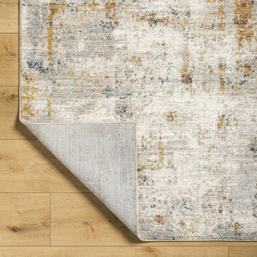 Close-up of Kacia Area Rug in beige and bone. Contemporary style with abstract pattern and visible rug backing. Fold