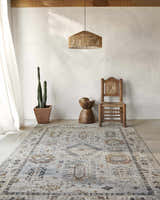 Farmhouse-style room featuring Kamau Cream & Blue Area Rug, wooden chair, side table, and cactus. Neutral, light-filled space. Roomscene-Rectangle