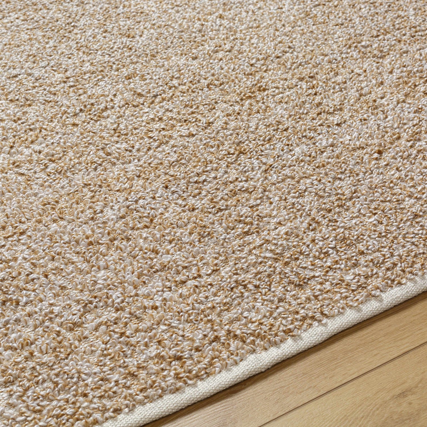 Close-up of the Kamil Beige Solid Area Rug showing its lambswool color and hand woven texture. Texture
